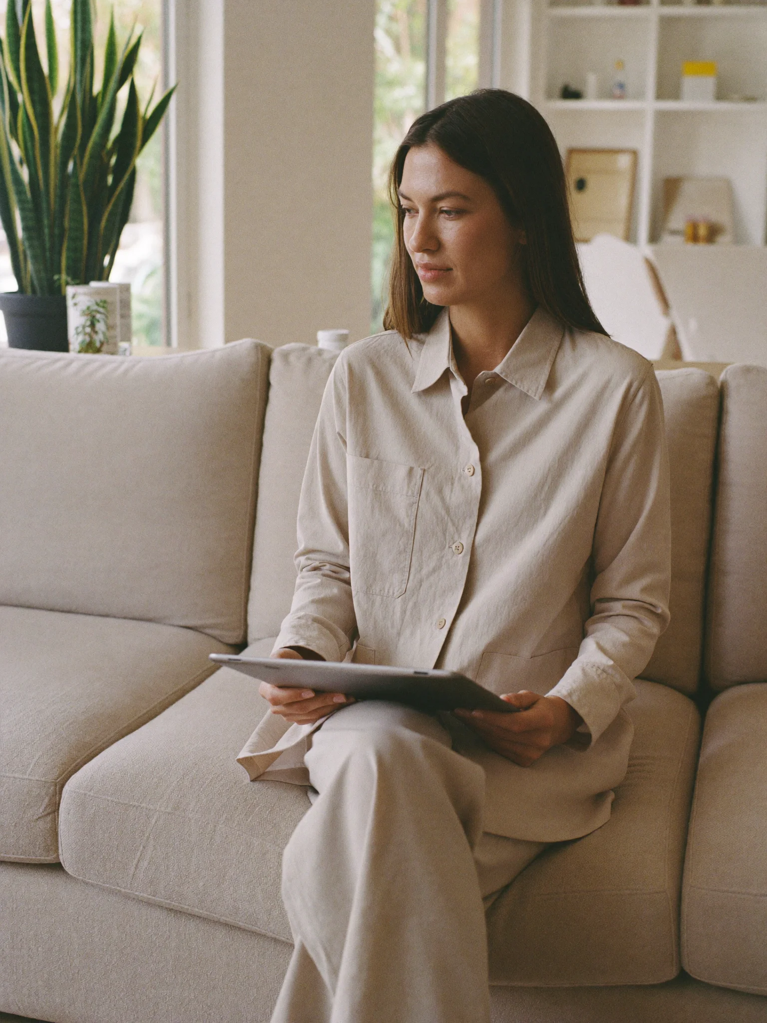A woman at home completing an online health assessment on a tablet