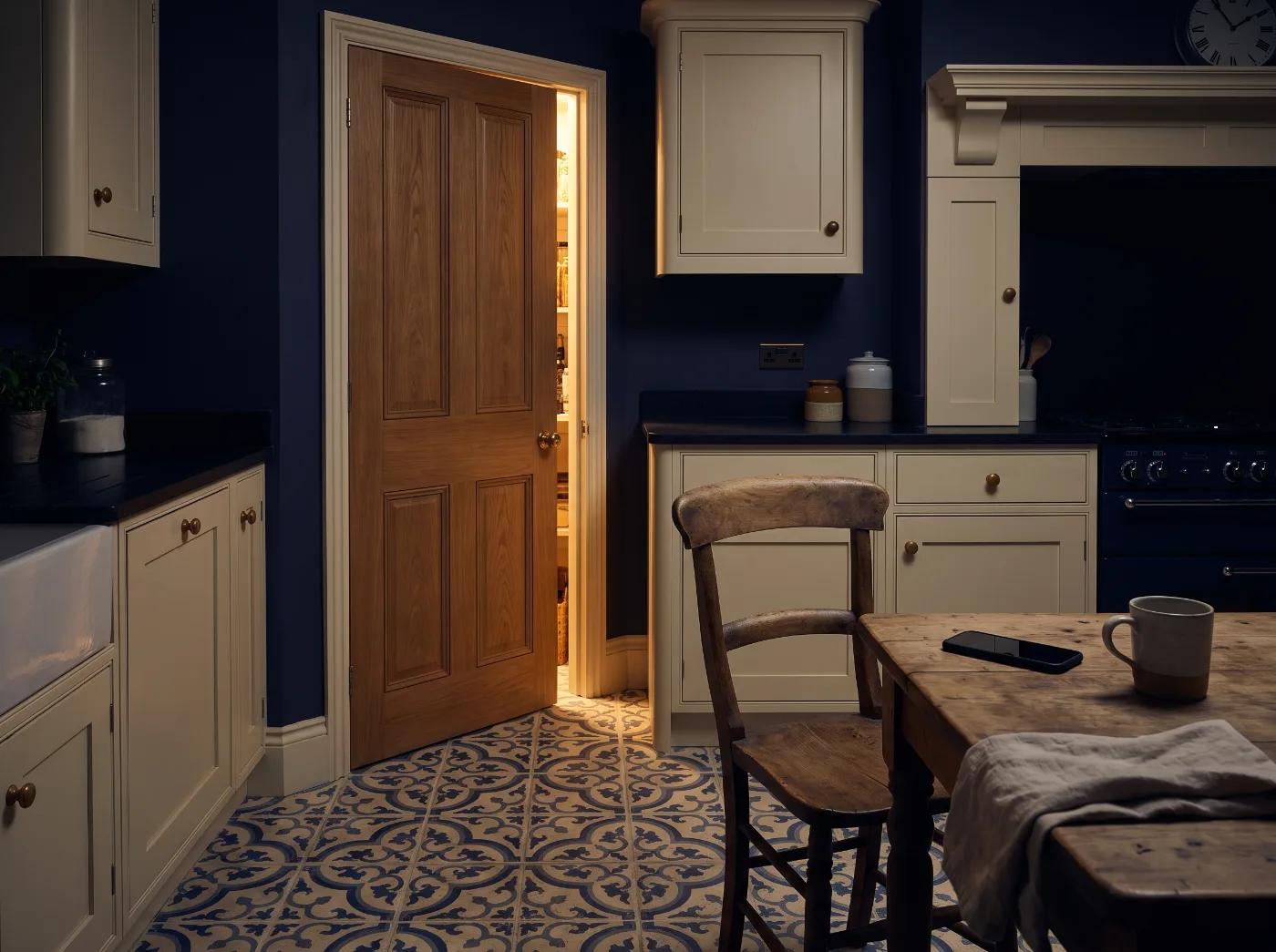 A quiet kitchen at night with the pantry door ajar